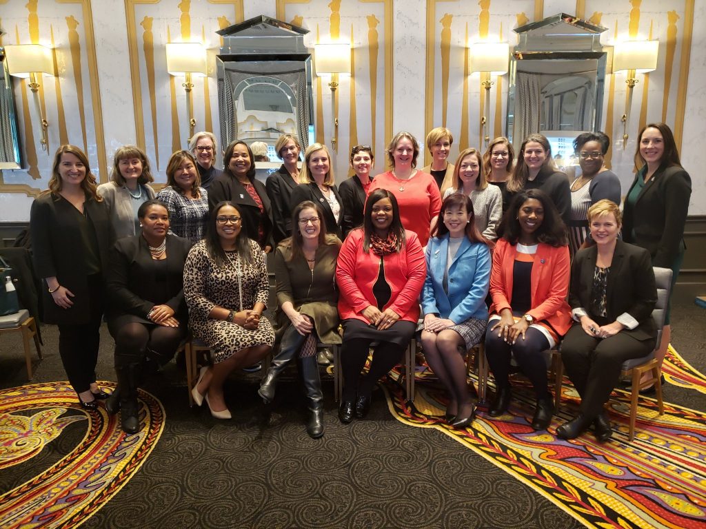 Group of over 20 women mayors sitting and smiling