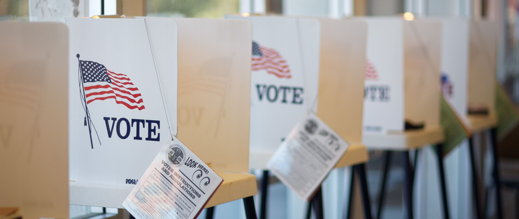 A voting booth with American flags