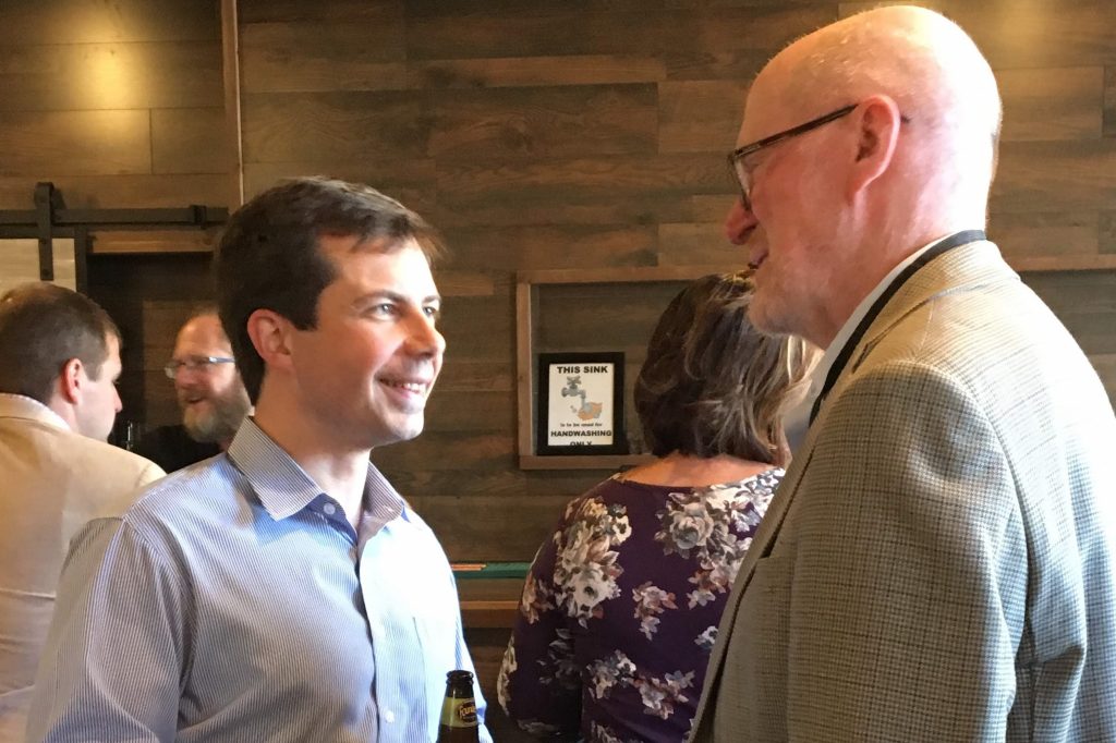 Two men stand together at a conference.