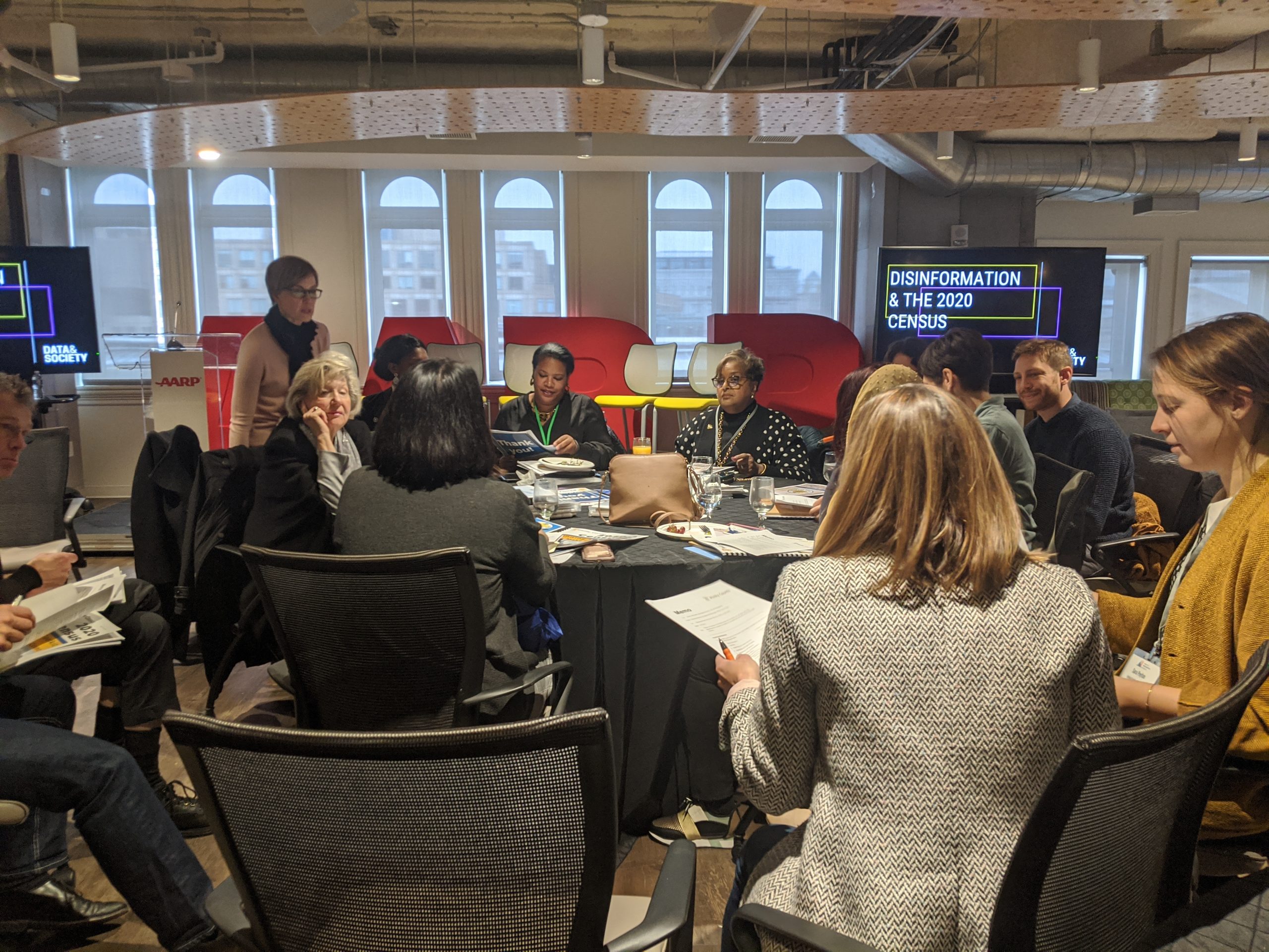 A group of conference attendees at a Mayors Innovation Project Meeting.
