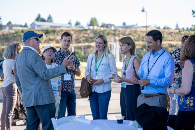 A group of Mayors Innovation Project conference attendees stand together smiling.