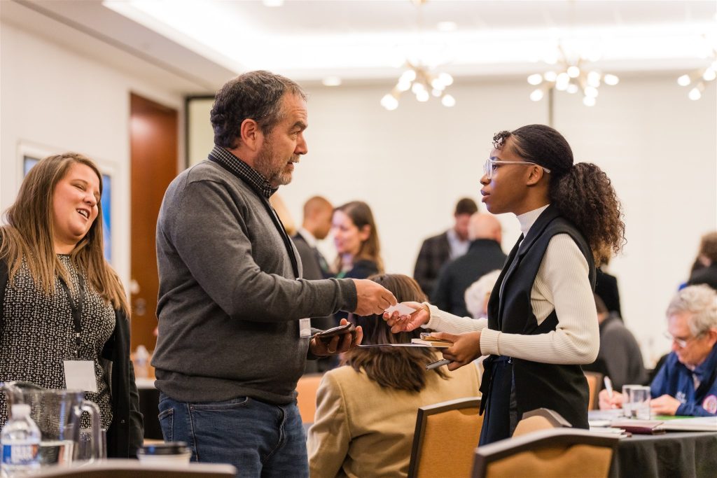 Conference attendees converse at an event.
