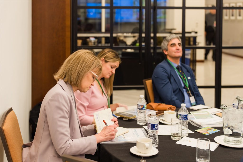 A group of mayors sits at a table.