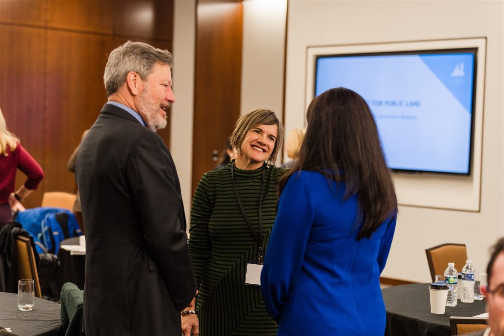Conference attendees converse at an event.