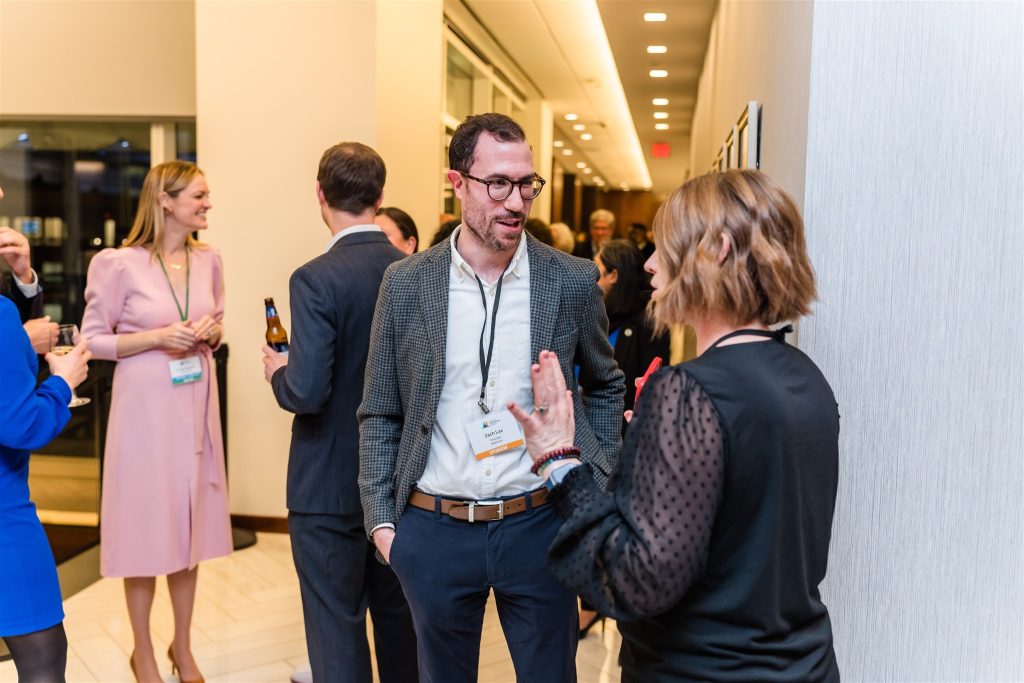 Conference attendees converse at an event.