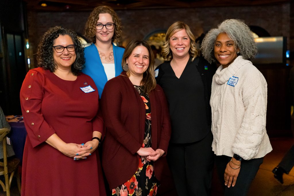 A group of women mayors standing together and smiling.