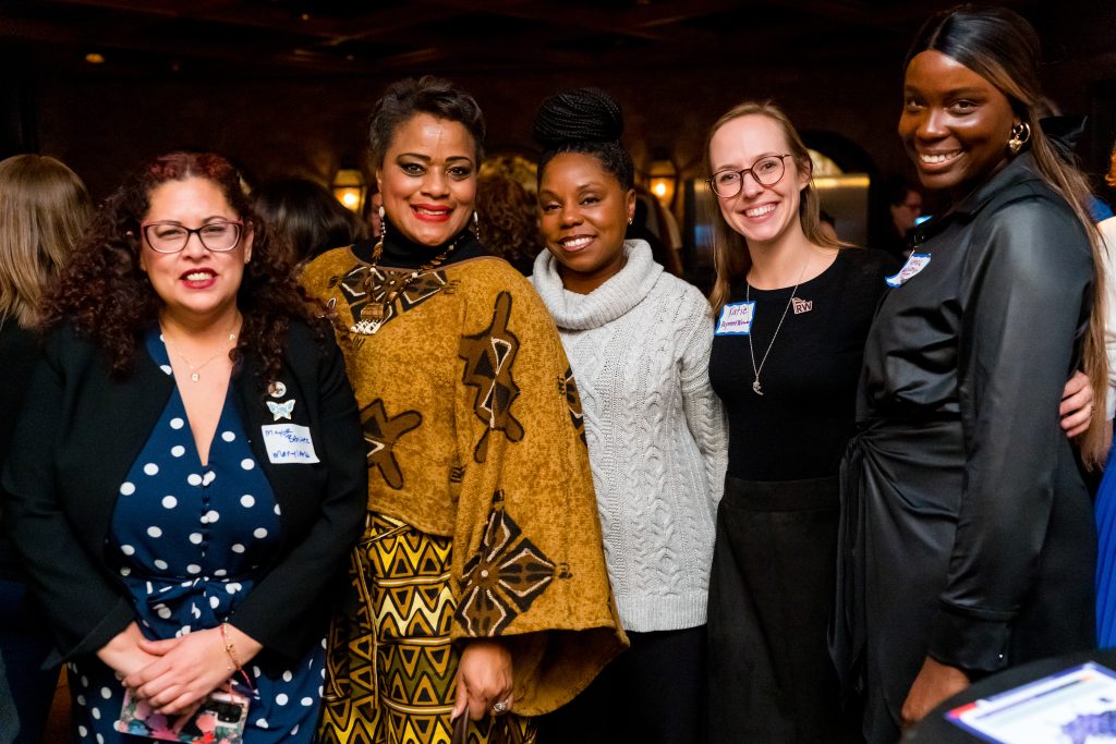A group of smiling women mayors stand together.
