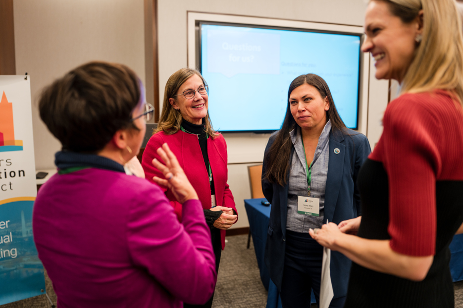 A group of women mayors speaking with one another at a Mayors Innovation Project event.