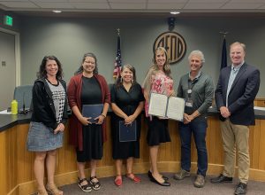 Six individuals from the Bend City Council pose with a proclamation proclaiming September 12-21, 2025 as Welcoming Week.