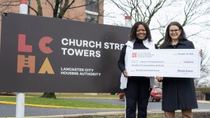 Mayor Danene Sorace stands holding a check that will be used for affordable housing investments.