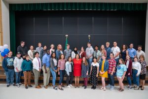 Mayor Victoria Woodards stands surrounded by children on the Mayors Youth Commission.