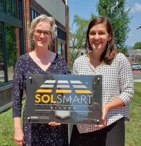 Hager-Smith being presented a silver award plaque from Sol-Smart.