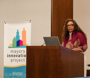 Mayor Chasity Wells-Armstrong speakers at podium at the Mayors Innovation Project Winter 2025 Meeting.