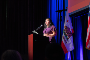 Mayor Ishii of Berkeley, CA delivering her 2025 State of the City speech at a podium in front of the California state flag.